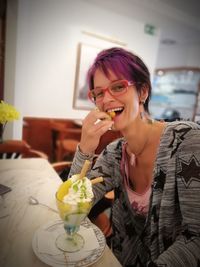 Portrait of a smiling young woman eating food