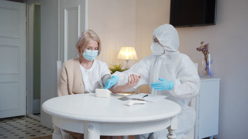 Doctor wearing mask examining patient