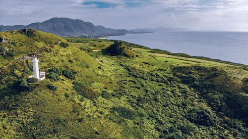 High angle view of sea and mountains against sky