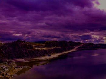 Scenic view of lake against cloudy sky