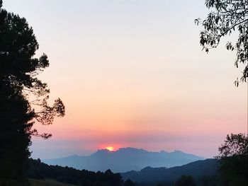 Scenic view of silhouette mountains against sky at sunset