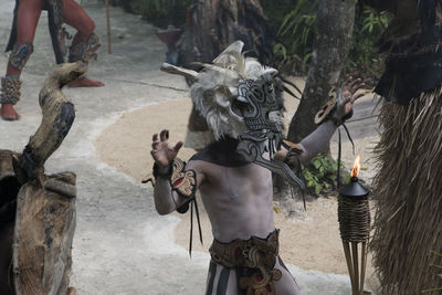 Shirtless man wearing traditional costumes