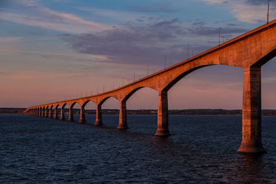 Low angle view of bridge over sea against sky