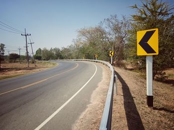 Road sign against sky