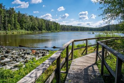 Scenic view of lake in forest against sky