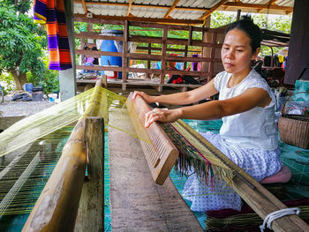 Woman weaving carpet at workshop