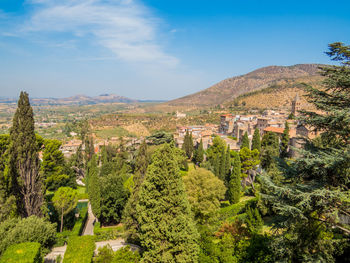 Panoramic view of trees and buildings against sky