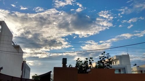 Low angle view of buildings against cloudy sky