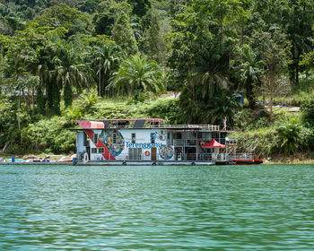 View of boat in river against trees