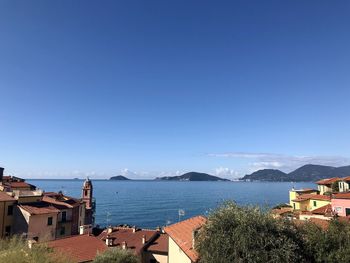 High angle view of townscape by sea against clear sky, tellaro