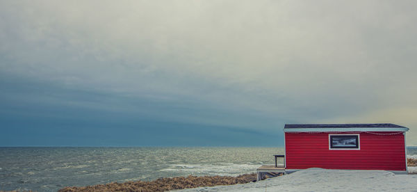 Lonely red house on the sea in kamchatka peninsula