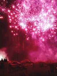 Low angle view of firework display at night