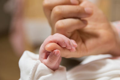 Close-up of woman holding hands