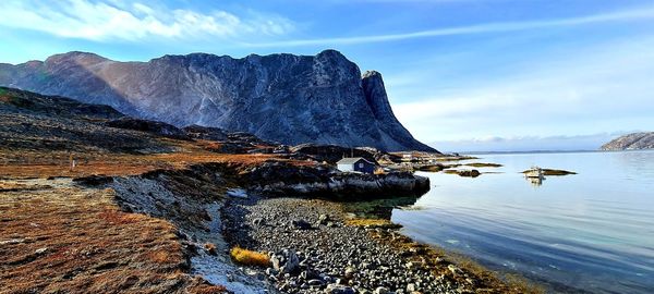 Rock formations by sea against sky