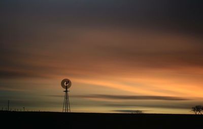 Low angle view of silhouette windmill against sky during sunset