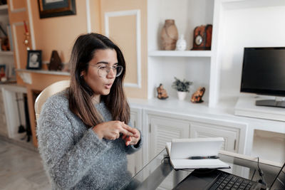 Young woman using mobile phone in office