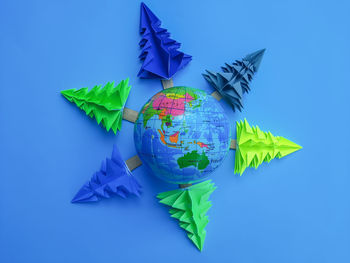 Low angle view of christmas tree against blue background