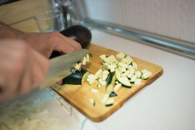 Cropped hand of woman preparing food