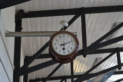 Low angle view of clock on wall