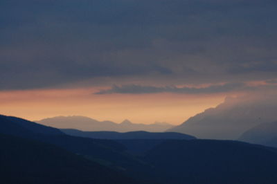 Scenic view of mountains against sky at sunset