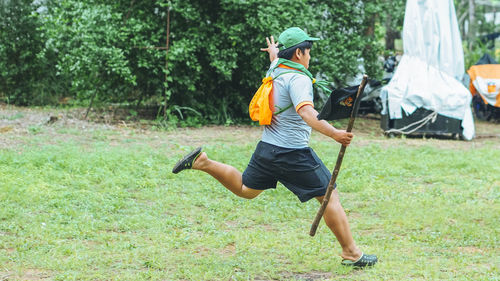 Side view of man jumping on grass