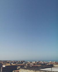 View of cityscape against clear blue sky