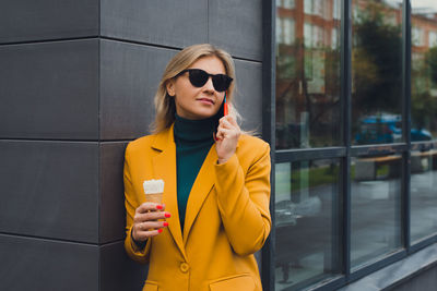 Portrait of young woman using mobile phone