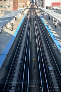 High angle view of railroad tracks at station in city