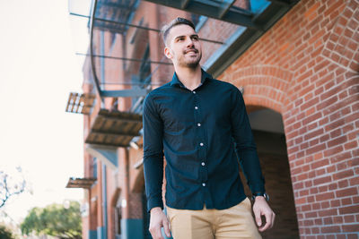 Low angle view of young man looking away