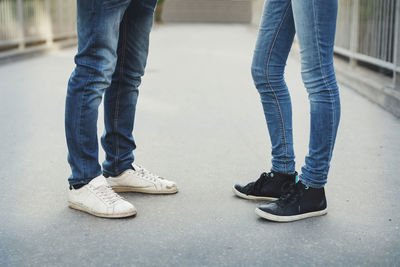 Low section of friends standing on bridge