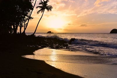 Scenic view of beach against sky during sunset