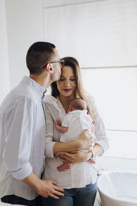 Portrait of smiling couple sitting in bathroom