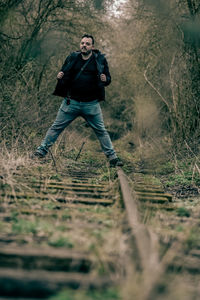 Full length of man running in forest