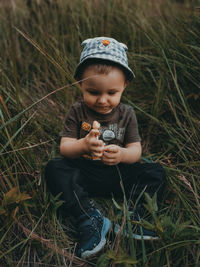 Full length of a boy holding ball on field