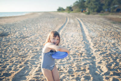 Cute european child girl summer holidays and adventures. active games on the sea coast.