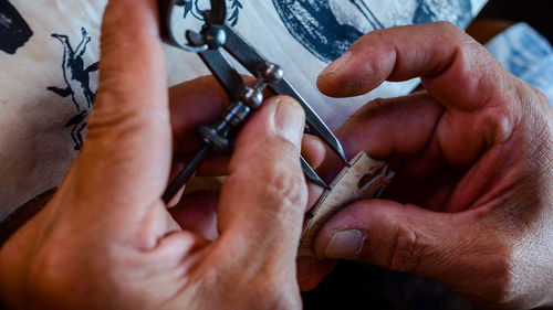 Violin maker luthier changing bridge of a handmade baroque violin