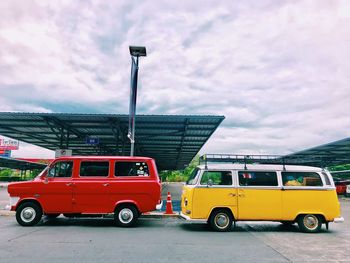 Vintage car on road against cloudy sky