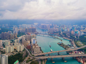 High angle view of river and buildings against sky
