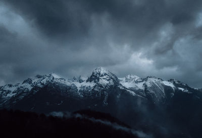 Scenic view of snowcapped mountains against sky