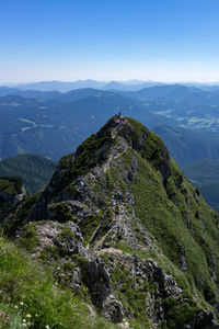 Scenic view of mountains against blue sky