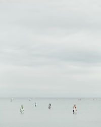 People on beach against sky