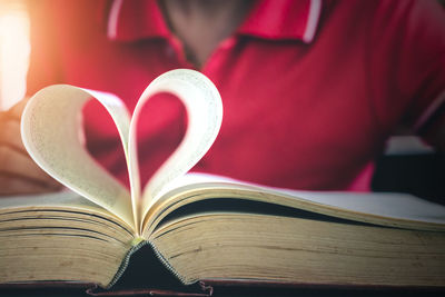 Close-up of heart shape on book