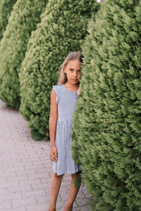 Portrait face of candid offended upset little kid girl of eight years old with long blond hair 