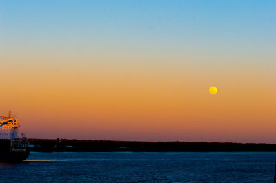 Scenic view of sea against orange sky