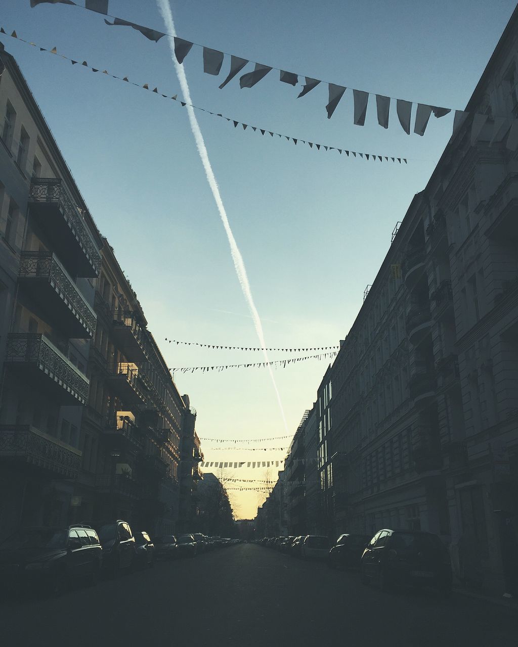 transportation, architecture, built structure, car, building exterior, land vehicle, street, road, city, the way forward, mode of transport, diminishing perspective, clear sky, city street, street light, sky, building, vanishing point, city life, traffic