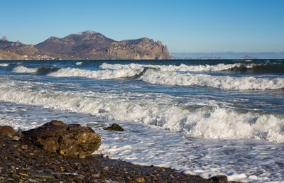 Waves with white foam in the crimean landscape.