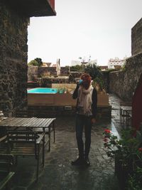 Full length of young woman standing on terrace