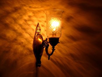 Street light against orange sky