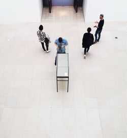 High angle view of people standing on floor