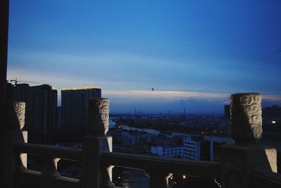 View of cityscape against blue sky